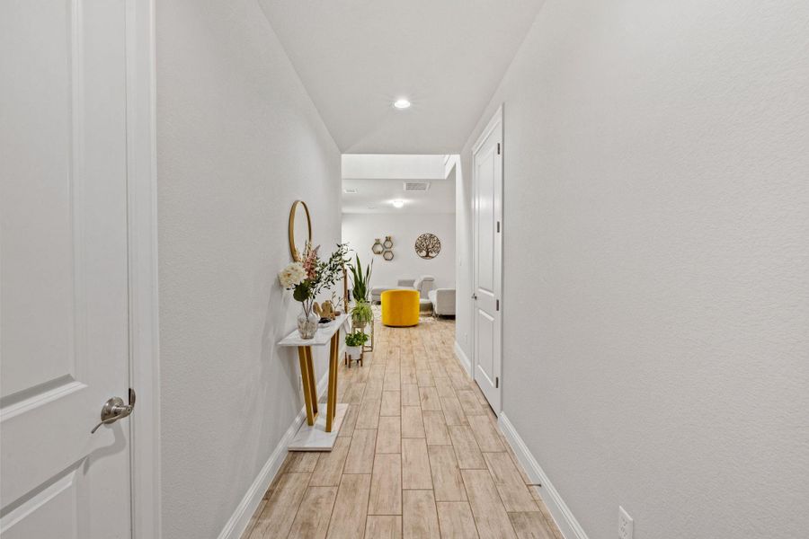 Hallway featuring light wood-style flooring and recessed lighting Hallway featuring light wood-style flooring and recessed lighting