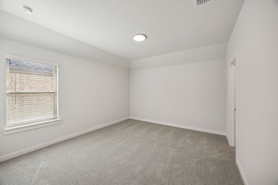 Bedroom in the Wimbledon home plan by Trophy Signature Homes – REPRESENTATIVE PHOTO