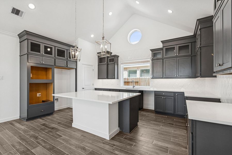 Gourmet island kitchen with grey stacked cabinets