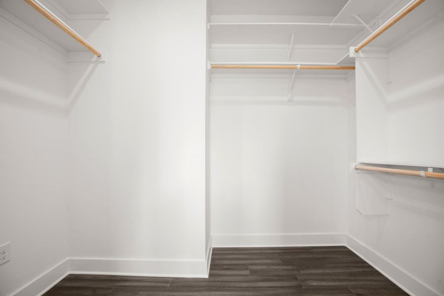 Ample storage solutions abound in this well-appointed closet, featuring durable wood flooring. Ample storage solutions abound in this well-appointed closet, featuring durable wood flooring.