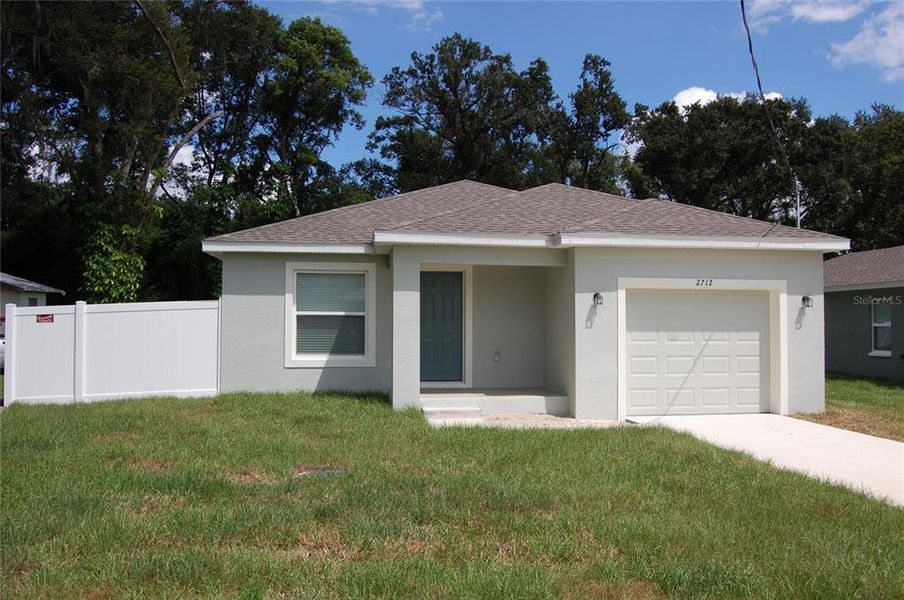 Front exterior of a new home in , Lakeland, FL, highlighting curb appeal (Image 1).