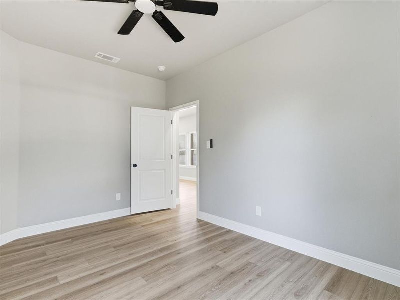 Unfurnished room with light wood-type flooring and ceiling fan Unfurnished room with light wood-type flooring and ceiling fan