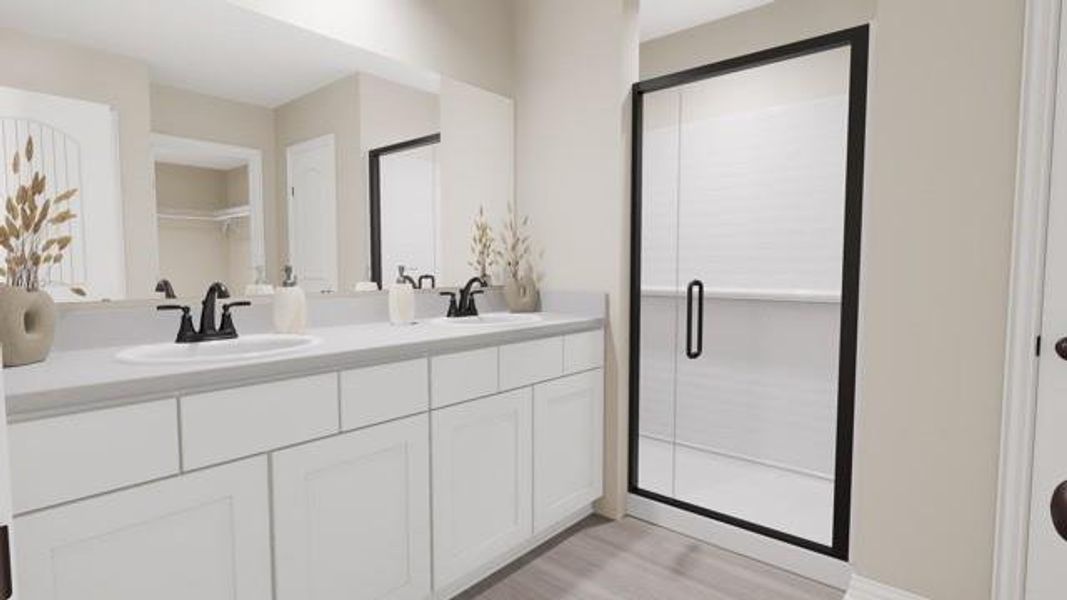 Full bath featuring double vanity, wood finished floors, and a shower stall