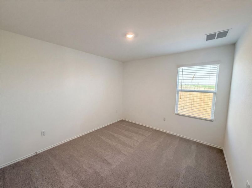 Carpeted empty room with baseboards