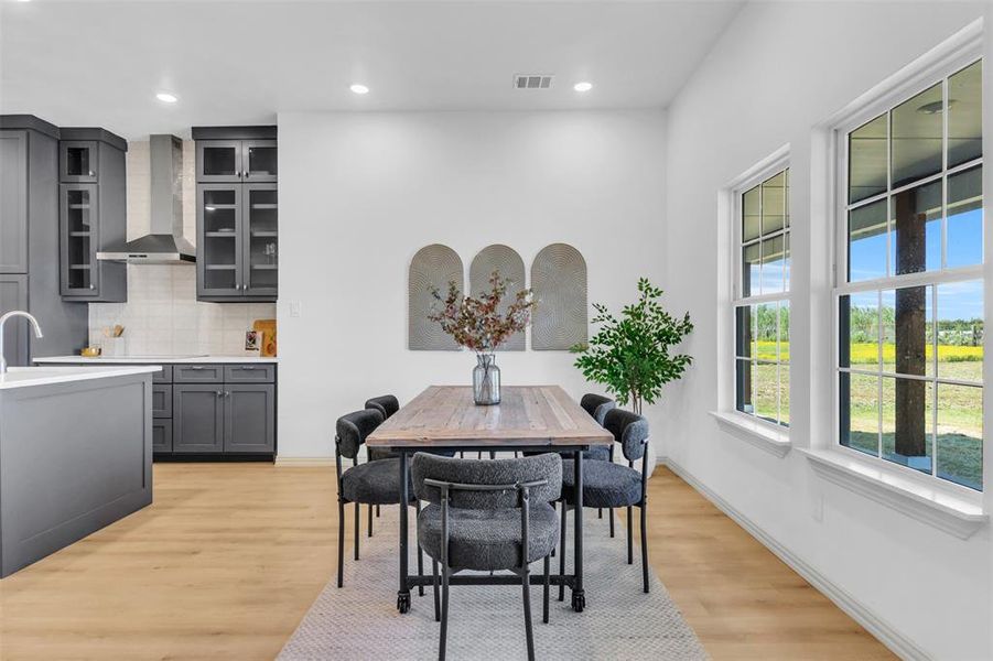 Dining space featuring light wood-type flooring and recessed lighting Dining space featuring light wood-type flooring and recessed lighting