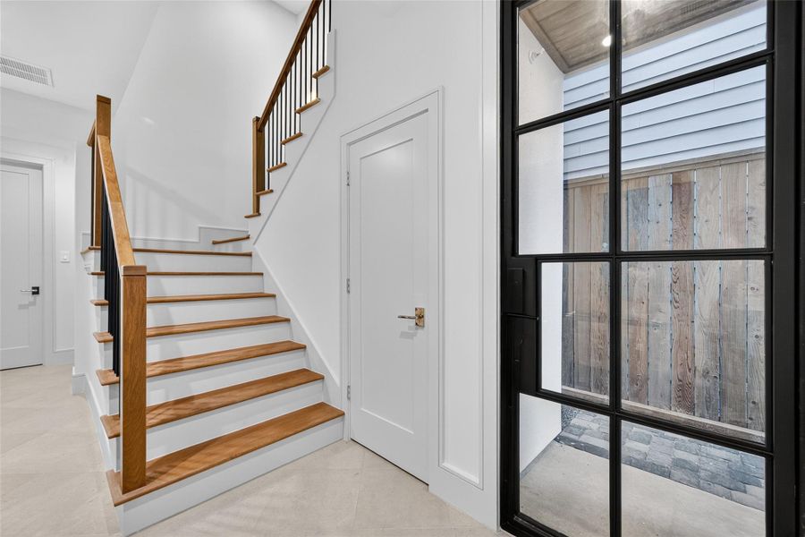 Guests enter through this custom iron-and-glass front door, hidden from the street and covered for inclement weather. A large under-stair closet is great for all kinds of storage. The home is also elevator capable, with a large open closet on each store for climate-controlled storage if you don't add the elevator. Guests enter through this custom iron-and-glass front door, hidden from the street and covered for inclement weather. A large under-stair closet is great for all kinds of storage. The home is also elevator capable, with a large open closet on each store for climate-controlled storage if you don't add the elevator.