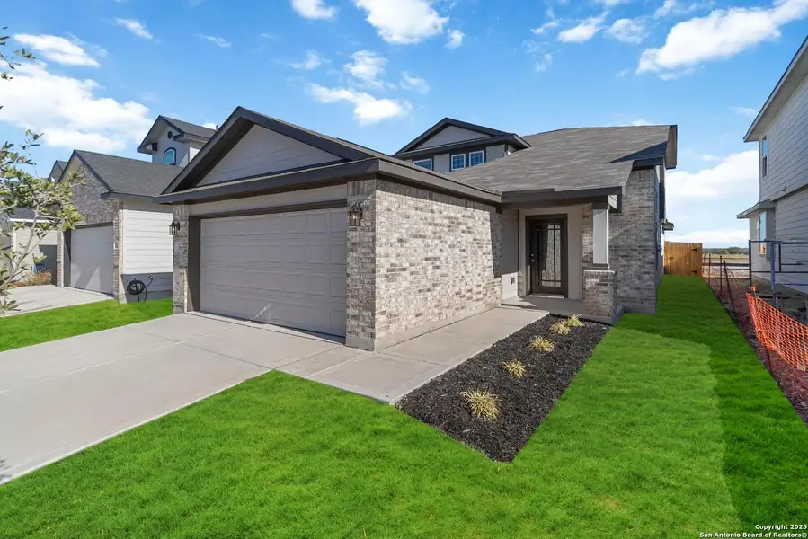 Front exterior of a new home in Katzer Ranch, Converse, TX, highlighting curb appeal (Image 2). Front exterior of a new home in Katzer Ranch, Converse, TX, highlighting curb appeal (Image 2).