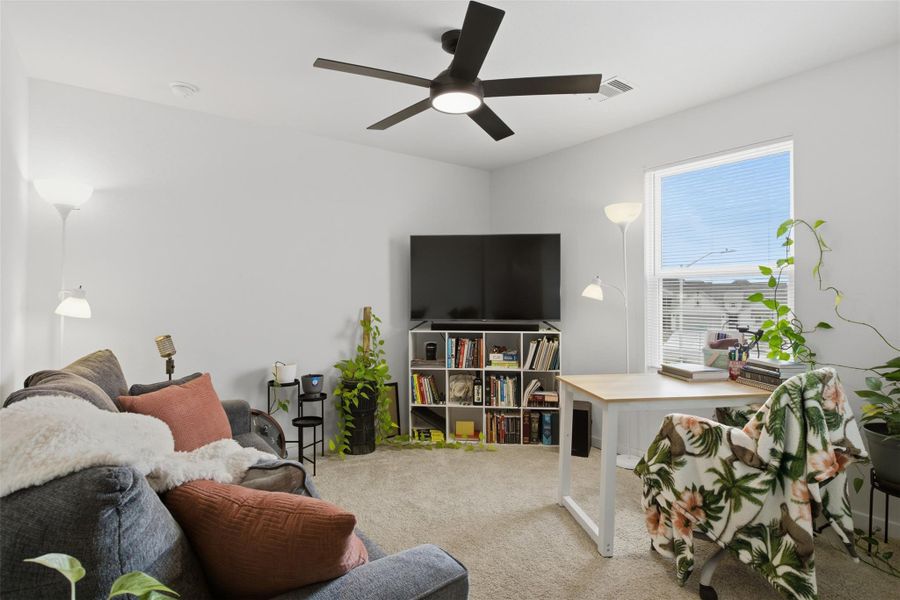 Sitting room featuring carpet flooring and a ceiling fan