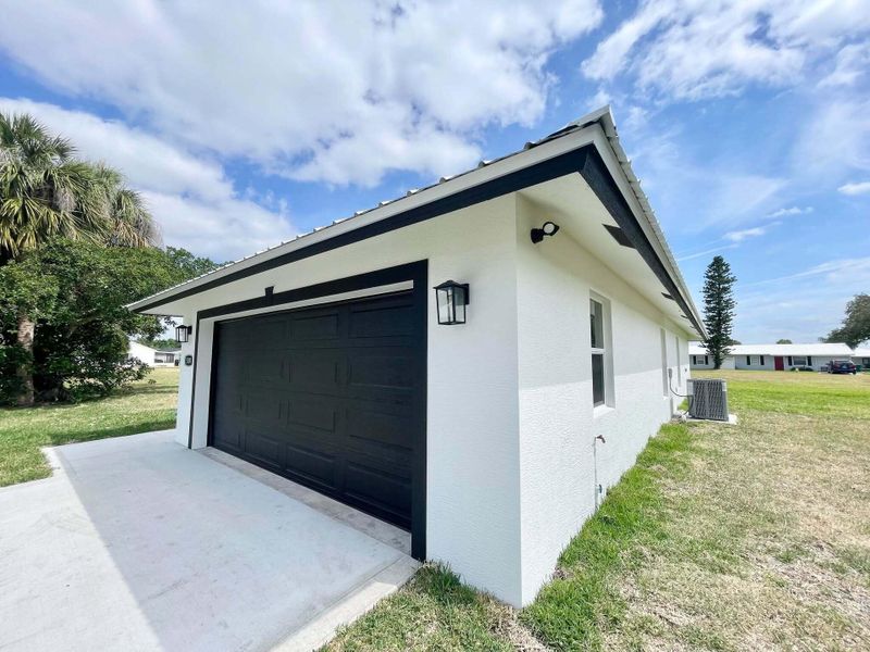 Front exterior of a new home in , Okeechobee, FL, highlighting curb appeal (Image 1).