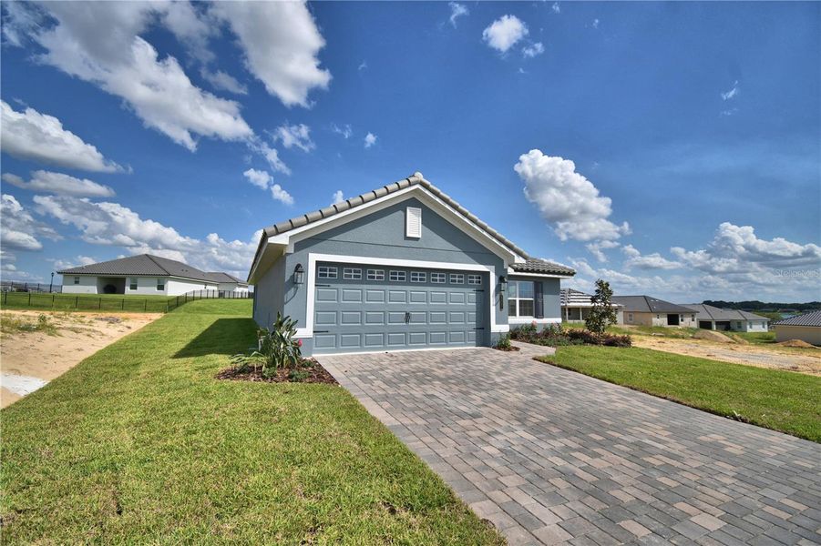 Front exterior of a new home in Lake Juliana Estates, Auburndale, FL, highlighting curb appeal (Image 19).