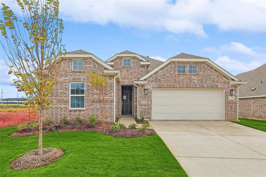 Front of property featuring a garage and a front lawn