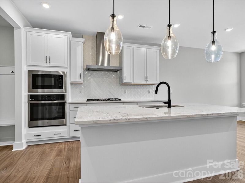 Gourmet Kitchen with White cabinets and white quartz countertops