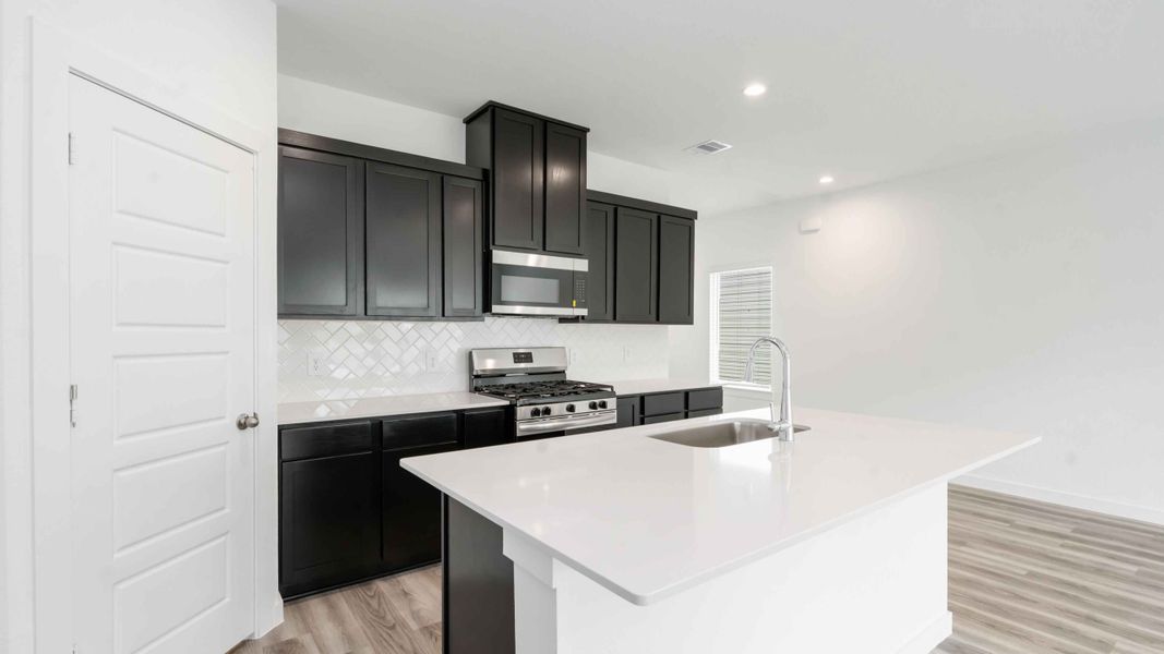 Representative furnished interior of a home built from the Jasmine by D.R. Horton in City Gate North, Houston (Image 4).