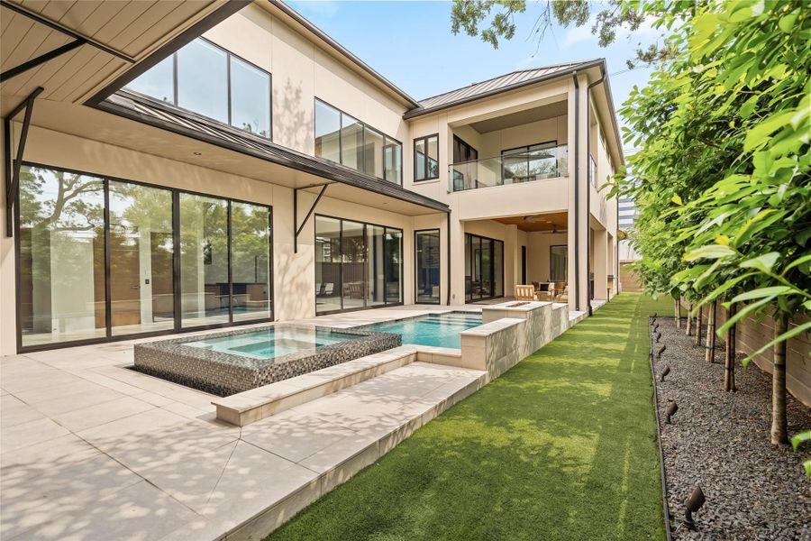 Expansive backyard with linear pool design and seamless connection to the home’s interior spaces