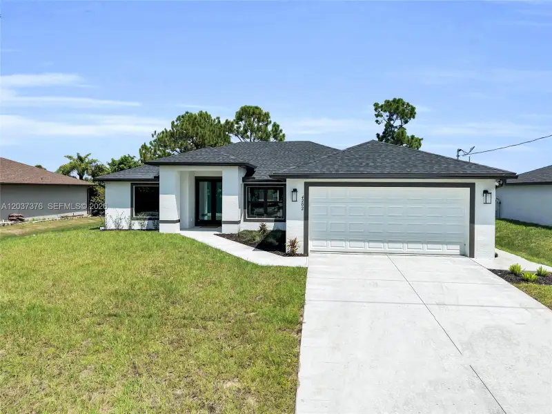 Front exterior of a new home in , Lehigh Acres, FL, highlighting curb appeal (Image 27).