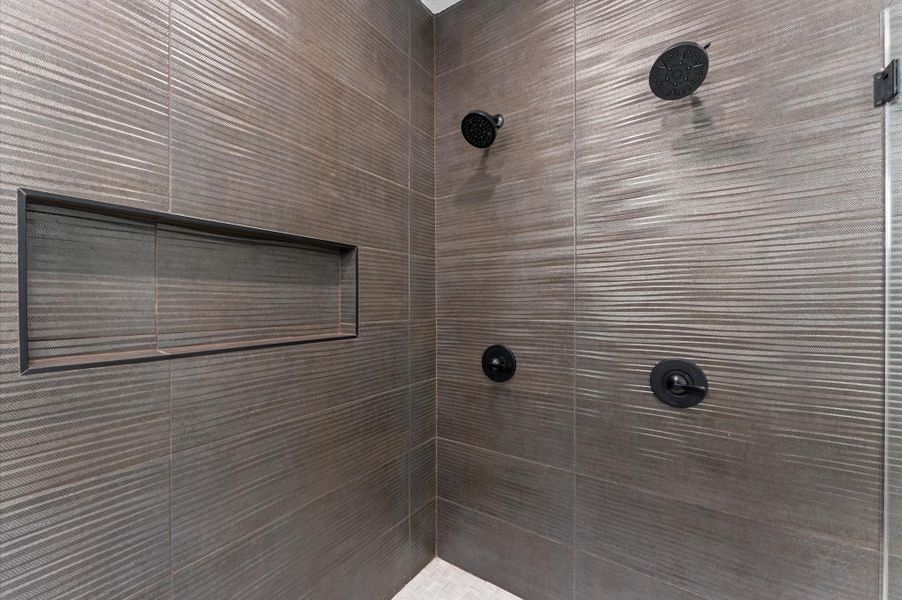 Two shower heads and lots of room on the recessed shelf for shampoo, conditioner, and body washes.