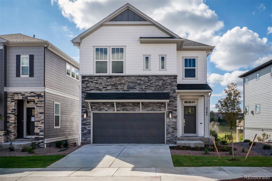 Front exterior of a new home in Trailside at Cottonwood Creek, Colorado Springs, CO, highlighting curb appeal (Image 1).
