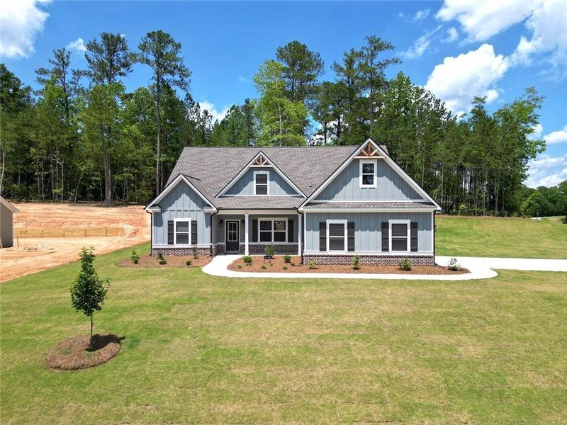 Front exterior of a new home in Woodland Hills, Loganville, GA, highlighting curb appeal (Image 12). Front exterior of a new home in Woodland Hills, Loganville, GA, highlighting curb appeal (Image 12).