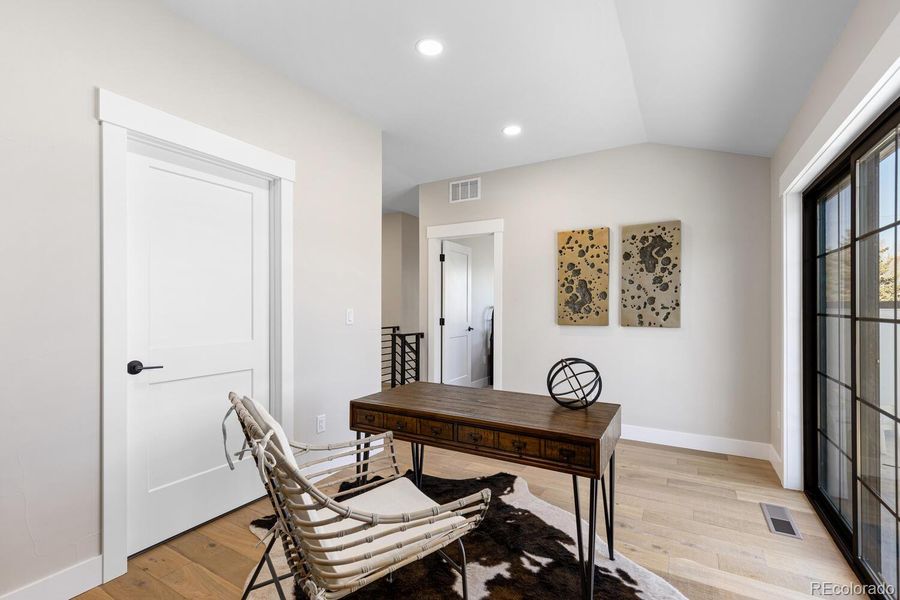 Loft that opens to a large rooftop deck throughmodern sliding doors Loft that opens to a large rooftop deck throughmodern sliding doors