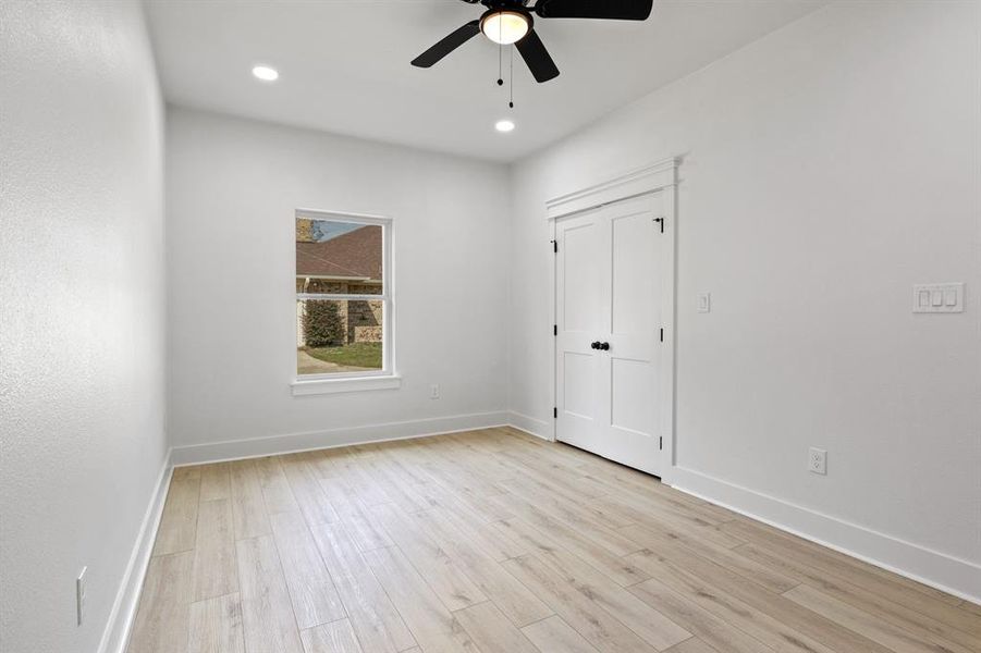 Unfurnished bedroom with light wood-style floors, recessed lighting, a ceiling fan, and a closet