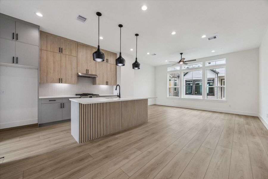 Open main living area with kitchen island, natural light, and entertaining flow Open main living area with kitchen island, natural light, and entertaining flow