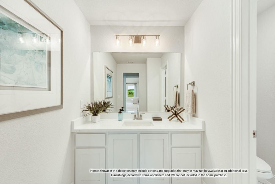 Bathroom with white vanity, single sink, large mirror, and three-bulb light fixture above Bathroom with white vanity, single sink, large mirror, and three-bulb light fixture above