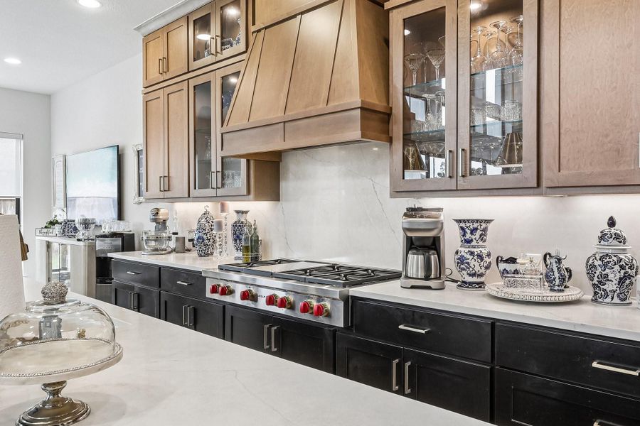 The chef's kitchen features a professional-grade 48" Wolf range with griddle