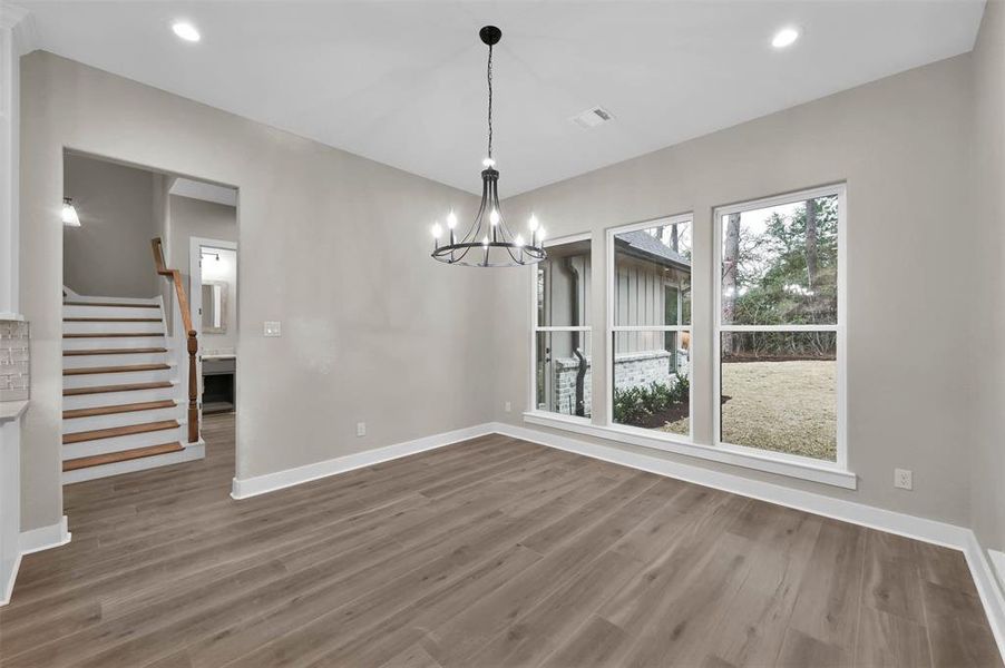 Breakfast nook where you can watch the birds and stairs leading to the game room with 2 closets above the garage.