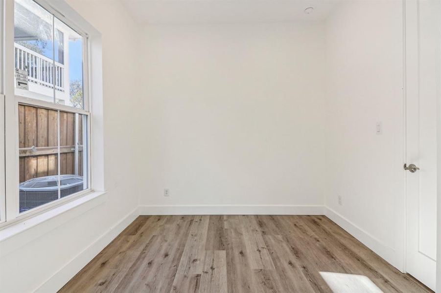 Empty room featuring light wood finished floors and baseboards