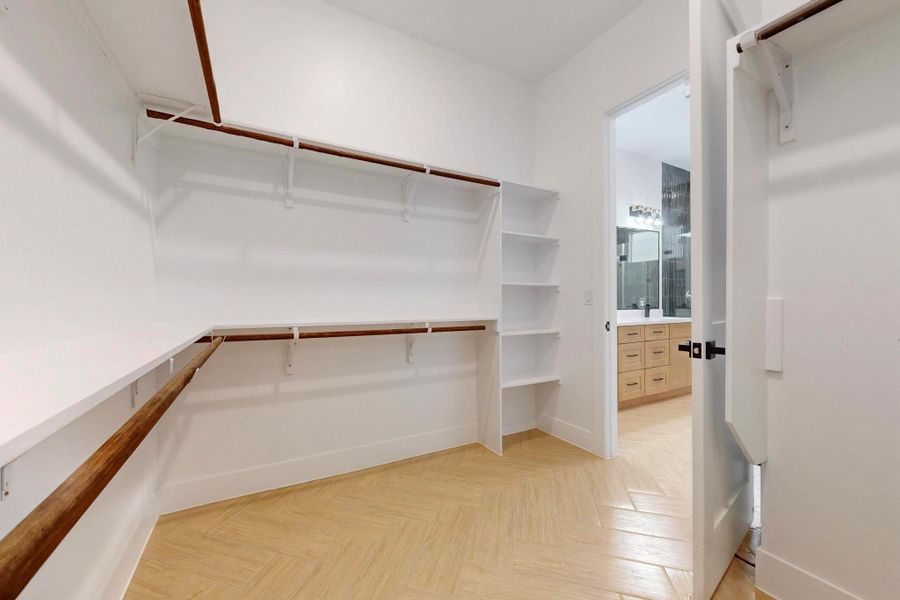 Walk in closet featuring parquet floors