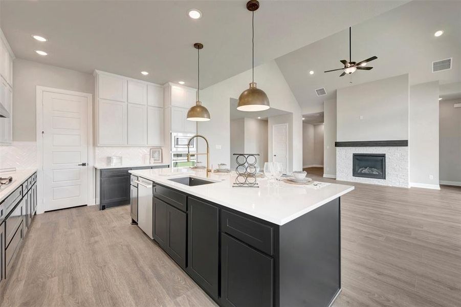 Kitchen island with a white countertop and dark cabinetry