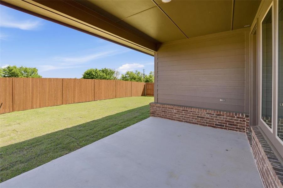 Fenced backyard featuring a patio
