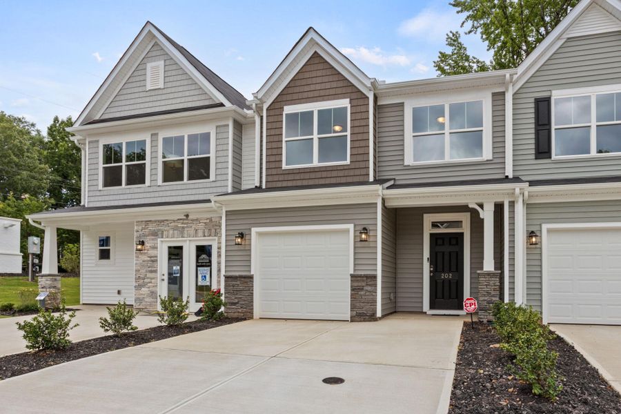 Front exterior of a new home in East Main Townes, Spartanburg, SC, highlighting curb appeal (Image 2). Front exterior of a new home in East Main Townes, Spartanburg, SC, highlighting curb appeal (Image 2).