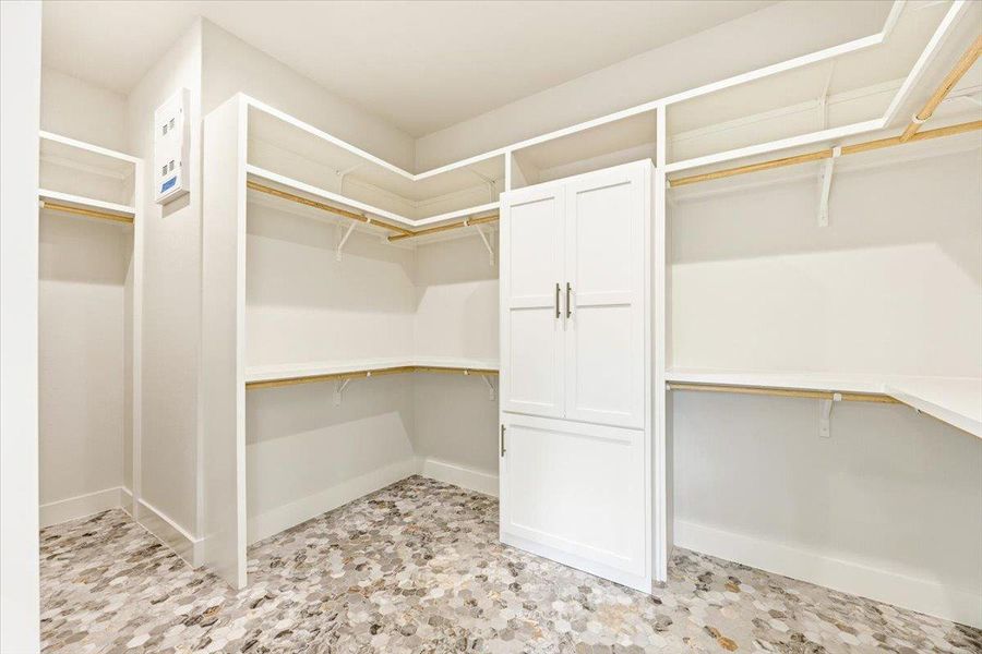 Abundant storage solutions with built-in shelving and patterned tile flooring create a highly functional space.