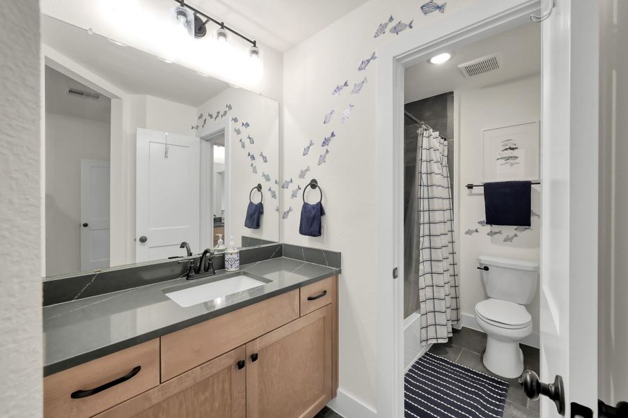 Convenient upstairs vanity connected to the full bath, offering added functionality for busy mornings.