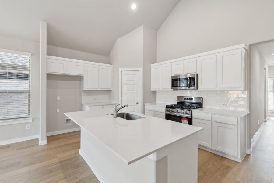 Kitchen in the Claret home plan by Trophy Signature Homes – REPRESENTATIVE PHOTO