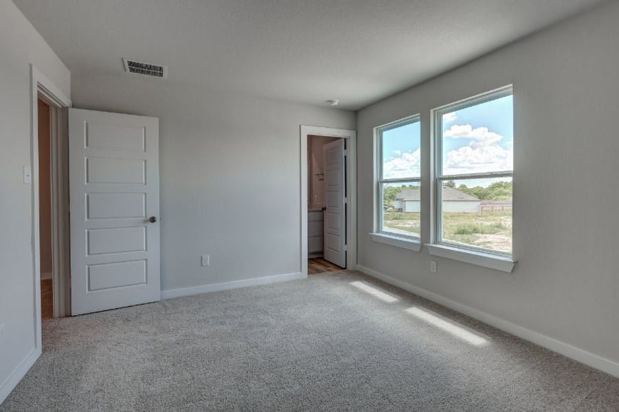 A room with white walls and a window.