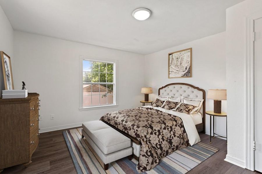 Bedroom featuring dark wood-type flooring and baseboards