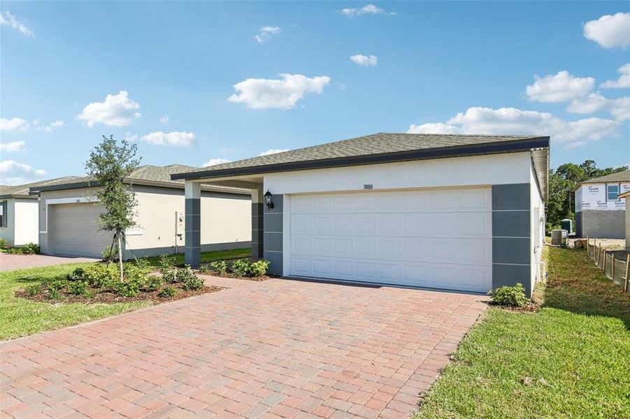 Front exterior of a new home in Villamar - Classic Series, Winter Haven, FL, highlighting curb appeal (Image 19). Front exterior of a new home in Villamar - Classic Series, Winter Haven, FL, highlighting curb appeal (Image 19).