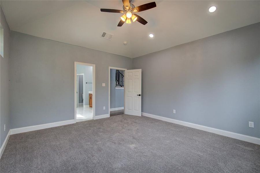 Master bedroom with ceiling fan and canned lights