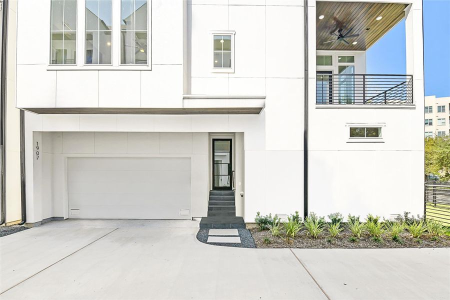 Enjoy the perfect balance of security and serenity with a fully gated front lawn and clean modern fencing. The covered entryway leads to a striking modern front door and a stylish balcony above, setting the tone for a home that blends architectural precision with everyday ease. Perfect for on-call physicians or medical professionals craving a peaceful retreat after long hours at the hospital.