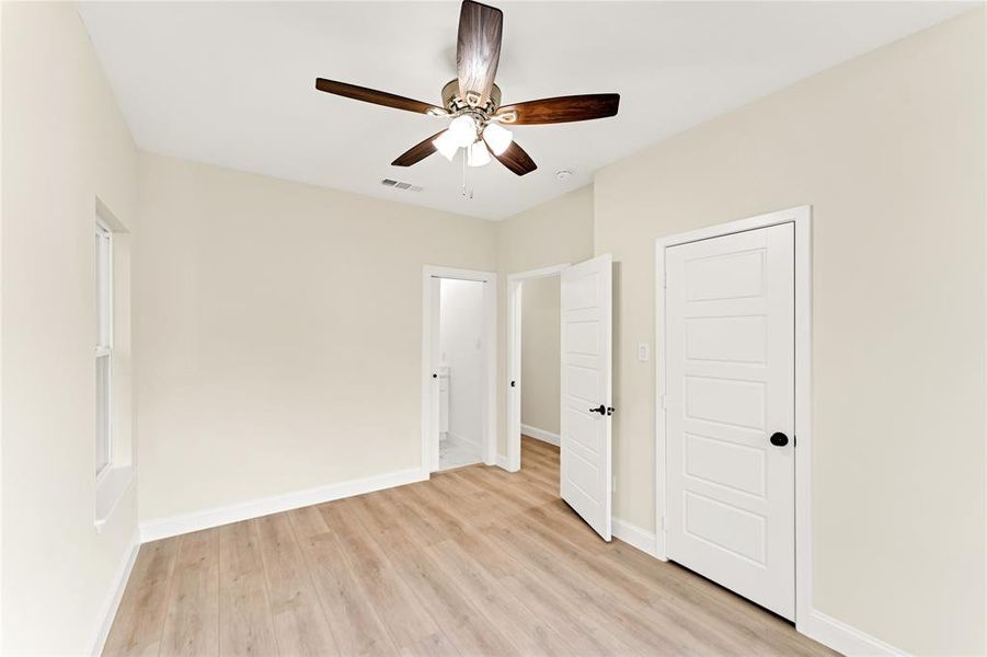 Unfurnished bedroom featuring ceiling fan and light wood-type flooring