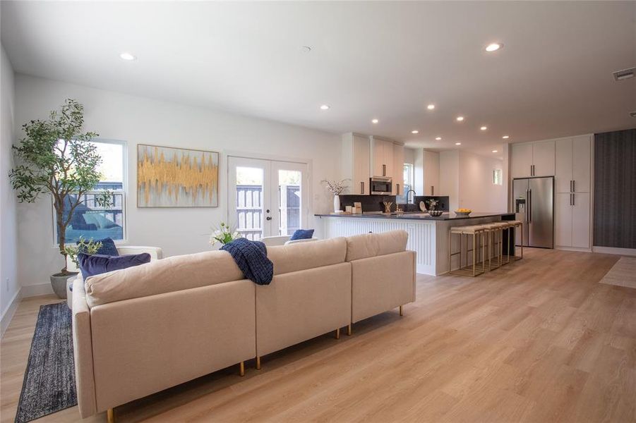 Living room with light hardwood / wood-style flooring and french doors