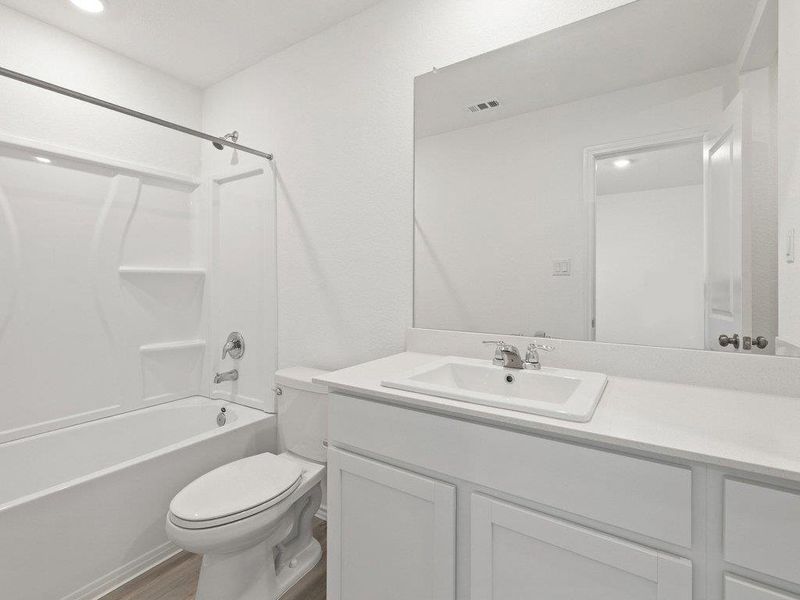 Full bathroom featuring vanity, shower / bathtub combination, and dark wood-style floors
