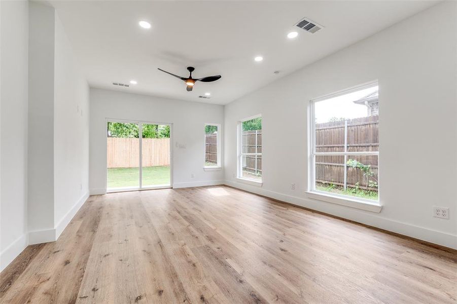 Living Room wood-style floors, baseboards, recessed lighting, and a ceiling fan
