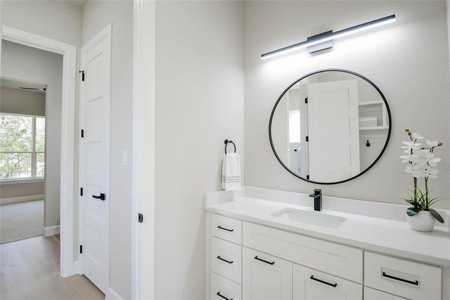 Bathroom featuring vanity and light wood-type flooring Bathroom featuring vanity and light wood-type flooring