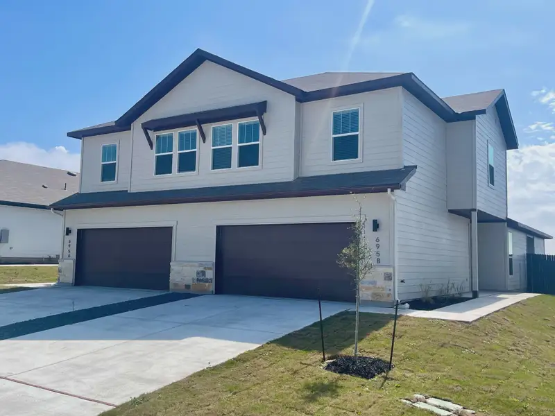 Representative exterior photo of a completed home built from the Duplex 1676 by TwoTen Communities in Amanda Park, San Antonio, TX (Image 1).