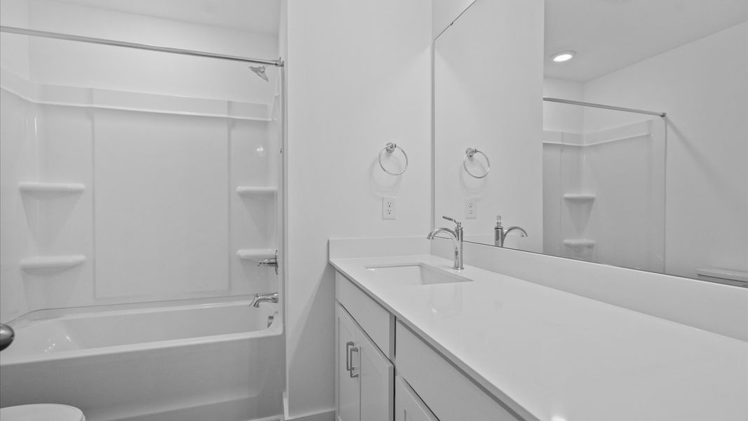 Accomplished bathroom design with sleek tile, high-quality cabinetry, and refined hardware Accomplished bathroom design with sleek tile, high-quality cabinetry, and refined hardware