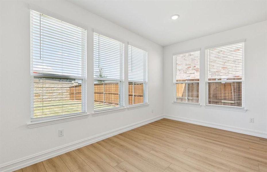 Dining nook off kitchen with large windows Dining nook off kitchen with large windows