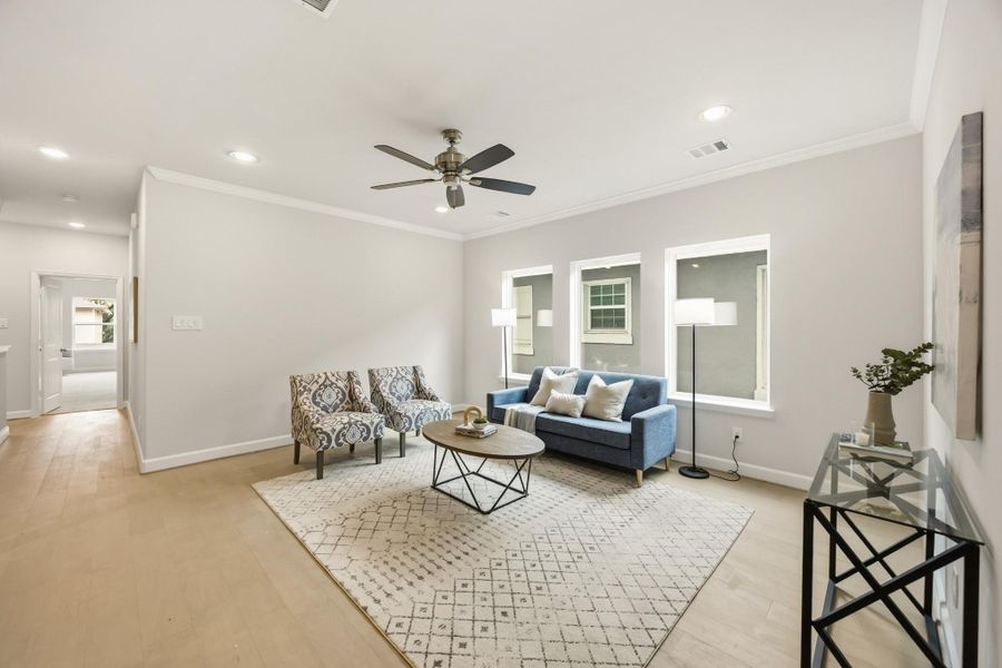 The second-story game room, a realm of leisure nestled between the serenity of the primary suite and the charm of a secondary bedroom, brightened by an expansive wall of windows. The second-story game room, a realm of leisure nestled between the serenity of the primary suite and the charm of a secondary bedroom, brightened by an expansive wall of windows.